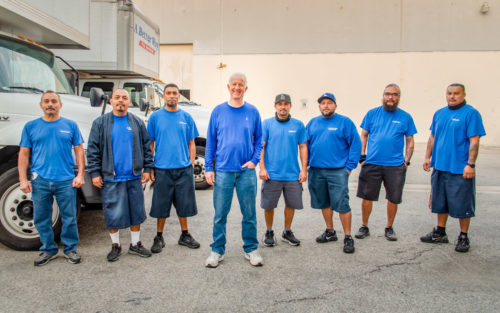 Los Angeles mover Tim Gordon, owner of A Better Way to Move, with two employees next to a moving truck.